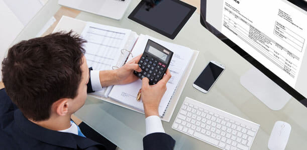 Man Doing Taxes with a Calculator